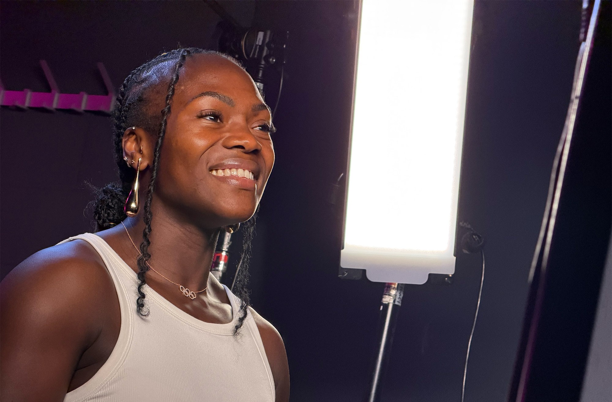 Clarisse Agbégnénou sourit lors d’un entretien, en haut blanc