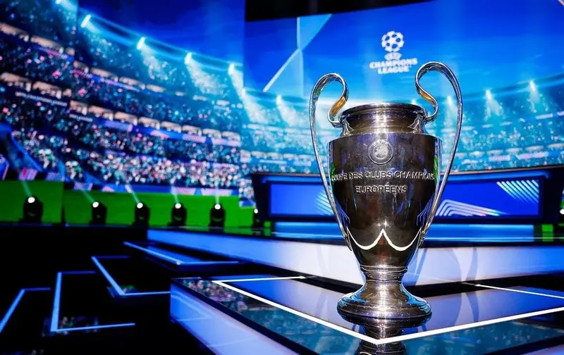 The Champions League trophy displayed on stage at the UEFA draw.