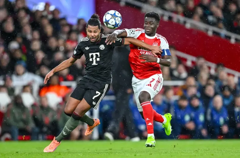 Bukayo Saka and Serge Gnabry during an Arsenal v Bayern Champions League match