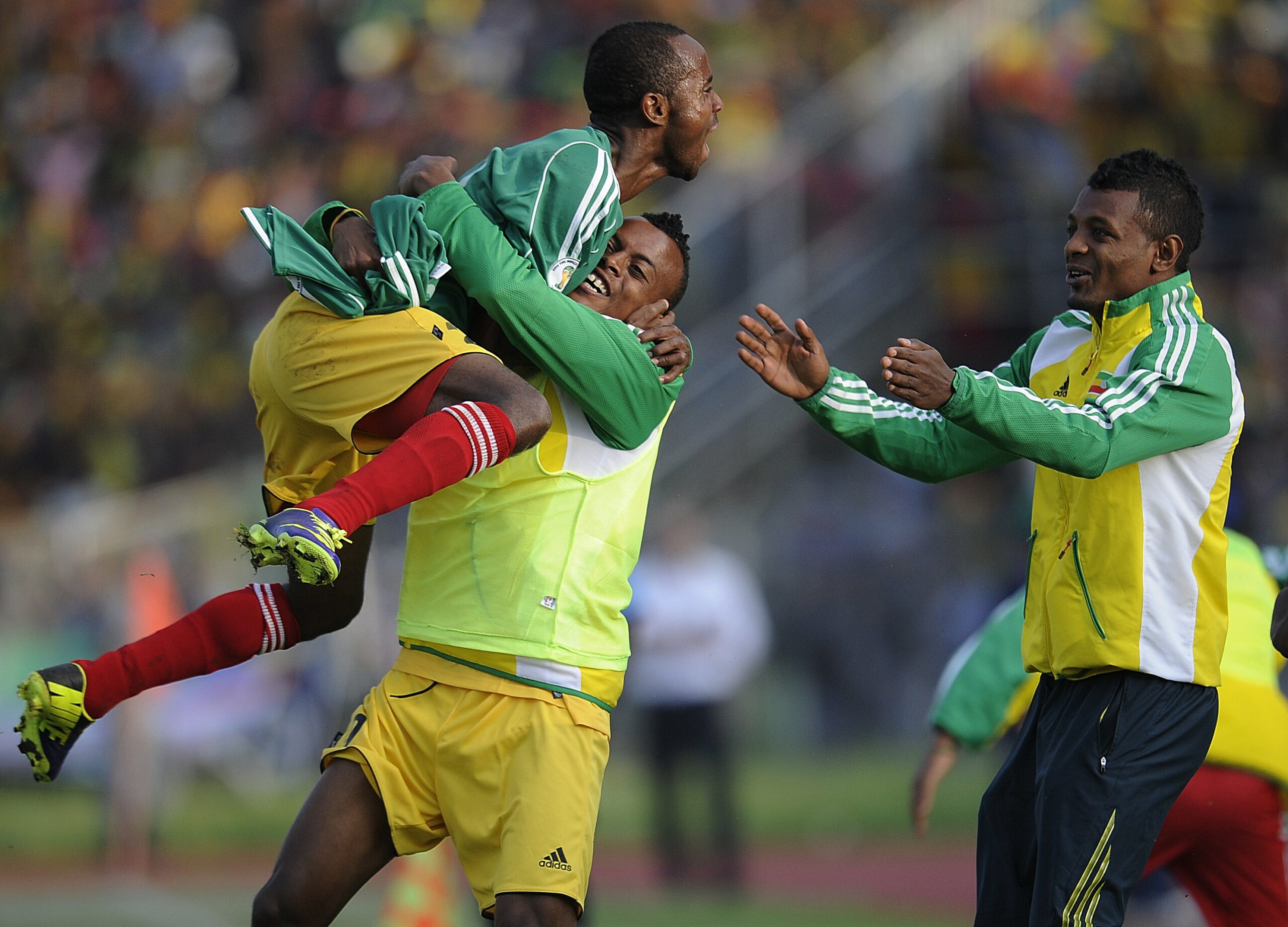 Ethiopian substitute players celebrate after scoring against Nigeria on October 13, 2013 during a 2014 World Cup qualifying match in Addis Ababa.    AFP PHOTO / SIMON MAINA