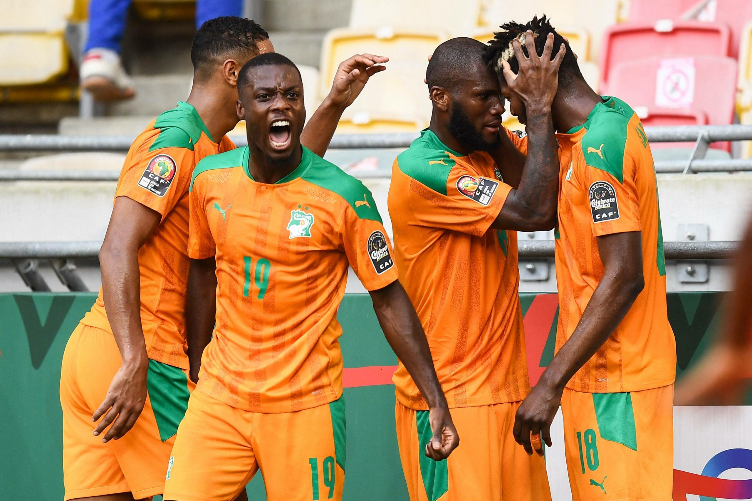 Ivory Coast's midfielder Franck Kessie (2nd R) celebrates with Ivory Coast's midfielder Ibrahim Sangare (R) and Ivory Coast's forward Nicolas Pepe (2nd L) after scoring his team's first goal during the Group E Africa Cup of Nations (CAN) 2021 football match between Ivory Coast and Algeria at Stade de Japoma in Douala on January 20, 2022.  (Photo by CHARLY TRIBALLEAU / AFP)