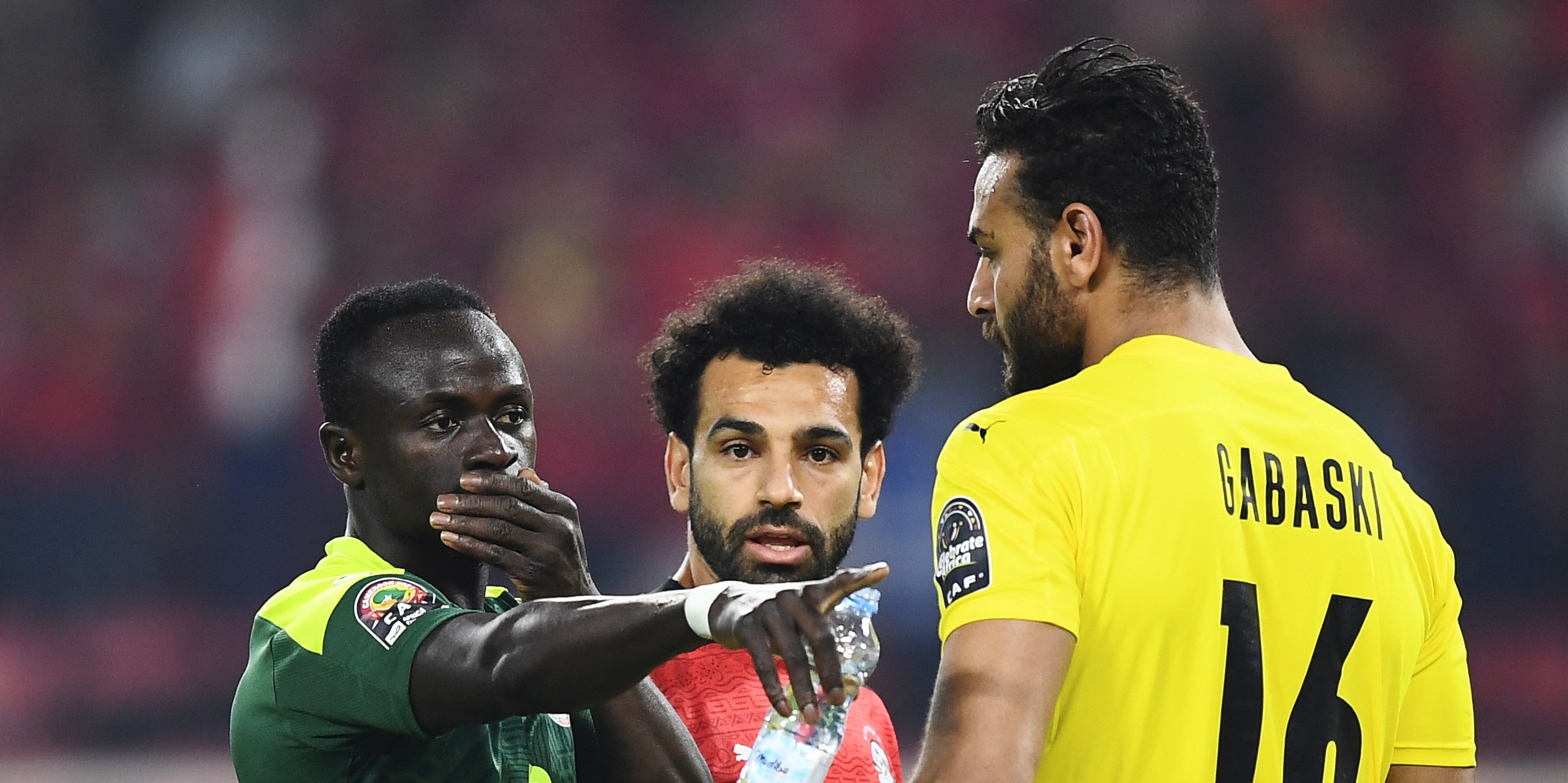 (From L) Senegal's forward Sadio Mane, Egypt's forward Mohamed Salah and Egypt's goalkeeper Mohamed Abogabal speak before the penalty kick during the Africa Cup of Nations (CAN) 2021 final football match between Senegal and Egypt at Stade d'Olembe in Yaounde on February 6, 2022. (Photo by CHARLY TRIBALLEAU / AFP) (Photo by CHARLY TRIBALLEAU/AFP via Getty Images)