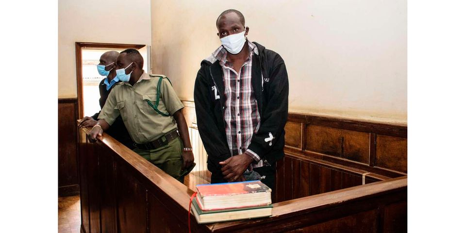 Ibrahim Rotich (R), husband of Kenyan distance runner Agnes Tirop who was found dead with stab wounds, appears in a dock for a hearing at the high court in Eldoret, Kenya, On December 1, 2021. - Rotich, who is commonly known as Emmanuel, denied the charges over the murder of the Kenyan distance running star. Tirop's death threw a spotlight on the pressures faced by the country's female athletes who pay a huge -- and often tragic -- price for their spectacular success in a male-dominated society. (Photo by Casmir ODUOR / AFP)