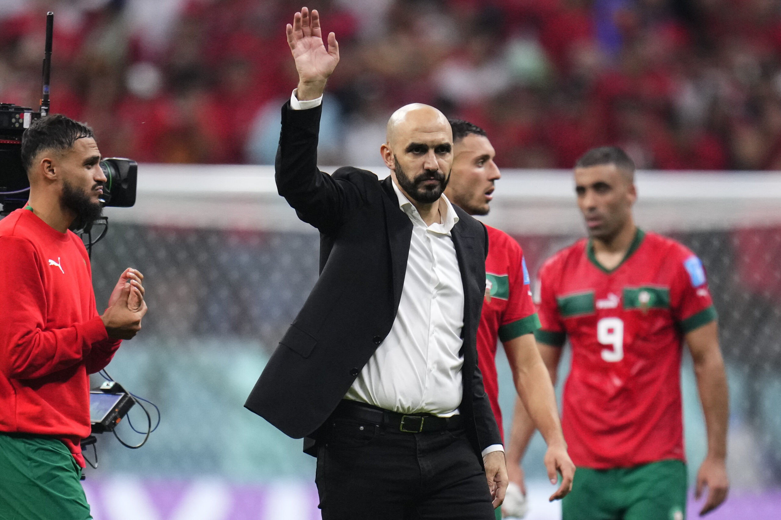 Morocco's head coach Walid Regragui waves to fans at the end of the World Cup semifinal soccer match between France and Morocco at the Al Bayt Stadium in Al Khor, Qatar, Wednesday, Dec. 14, 2022. France won 2-0 and will play Argentina in Sunday's final. (AP Photo/Manu Fernandez)