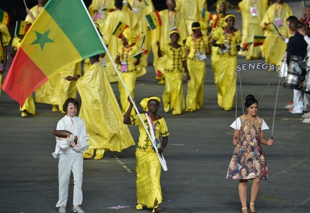 Senegal's flagbearer Hortance Diedhiou (C) leads her delegation during the opening ceremony of the London 2012 Olympic Games on July 27, 2012 at the Olympic Stadium in London.     AFP PHOTO / GABRIEL BOUYS        (Photo credit should read GABRIEL BOUYS/AFP/GettyImages)