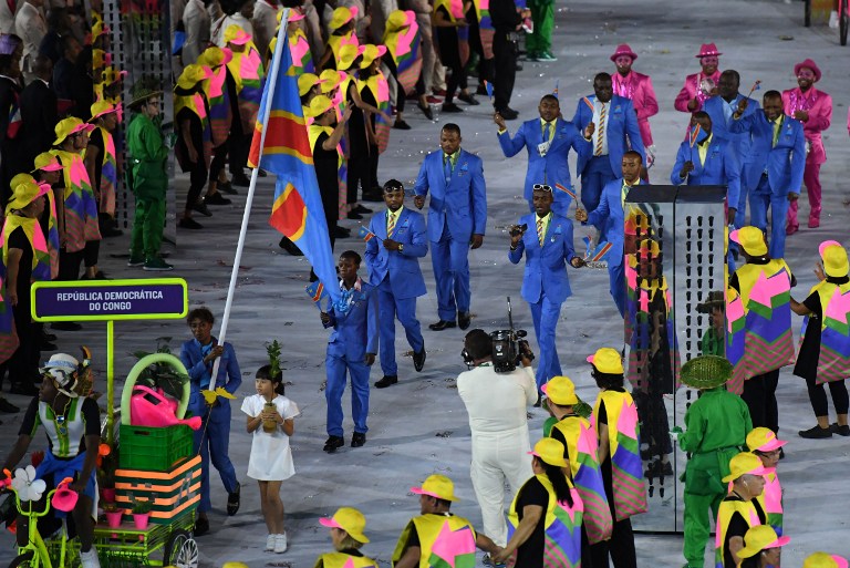 Democratic Republic of the Congo's flagbearer Rosa Keleku Lukusa leads her delegation during the opening ceremony of the Rio 2016 Olympic Games at the Maracana stadium in Rio de Janeiro on August 5, 2016. / AFP PHOTO / PEDRO UGARTE