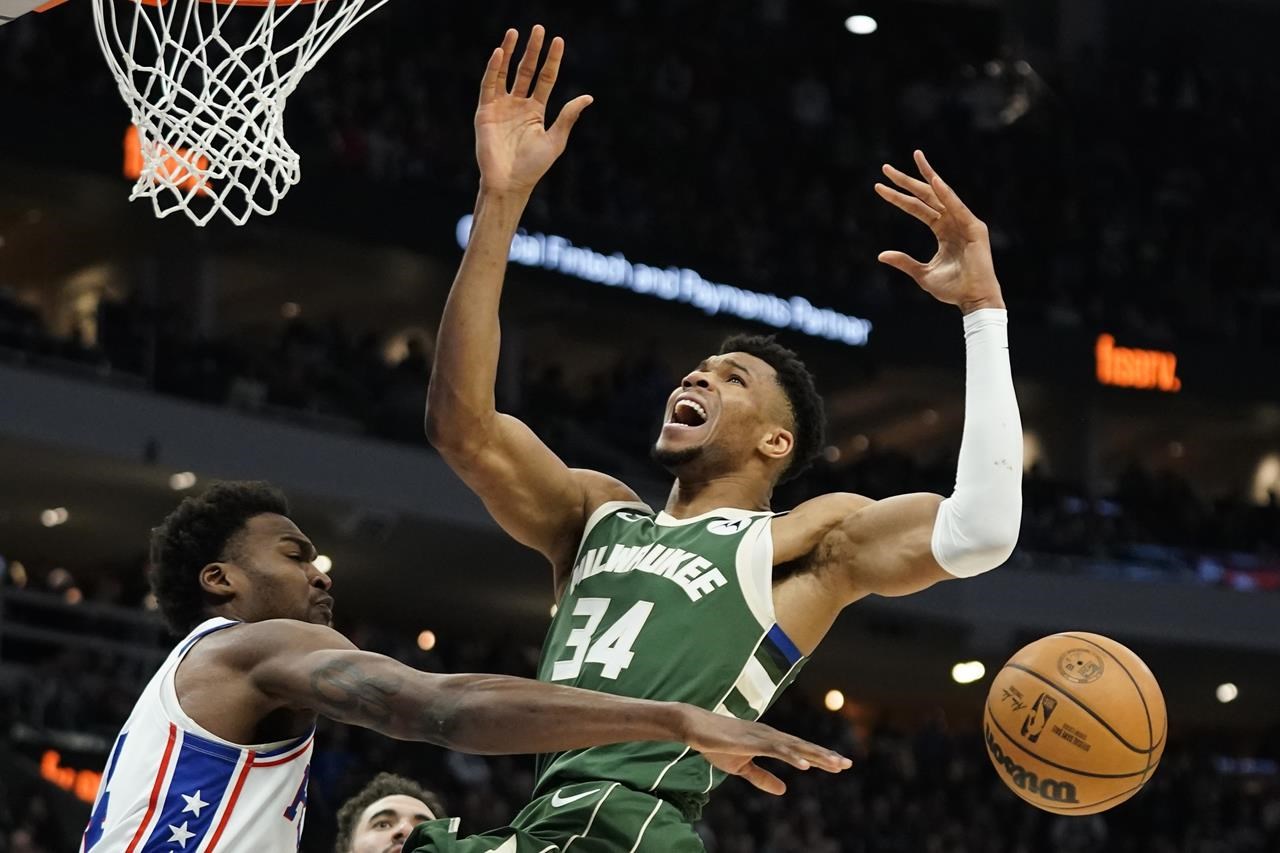 Milwaukee Bucks' Giannis Antetokounmpo (34) loses control of the ball against Philadelphia 76ers' Paul Reed during the second half of an NBA basketball game Saturday, March 4, 2023, in Milwaukee. (AP Photo/Aaron Gash)