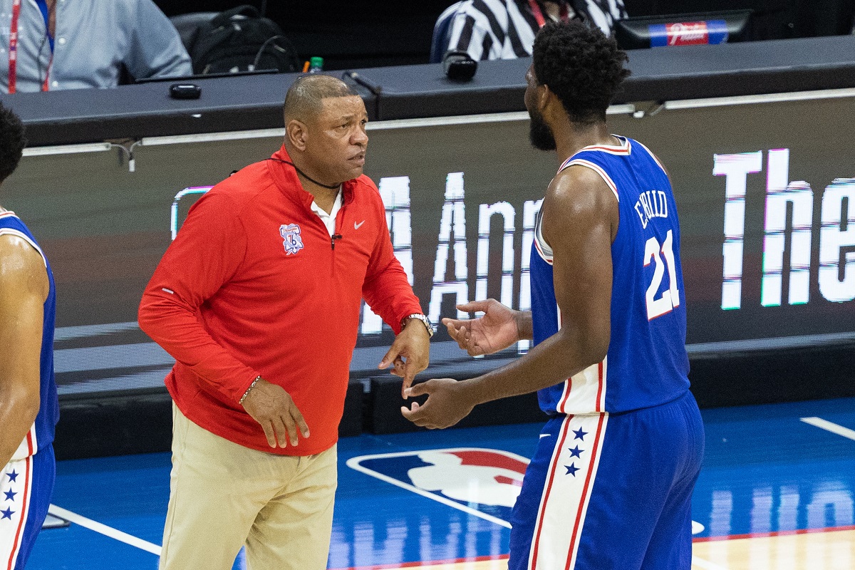 Jun 8, 2021; Philadelphia, Pennsylvania, USA; Philadelphia 76ers head coach Doc Rivers talks with center Joel Embiid (21) during the fourth quarter in game two of the second round of the 2021 NBA Playoffs against the Atlanta Hawks at Wells Fargo Center. Mandatory Credit: Bill Streicher-USA TODAY Sports