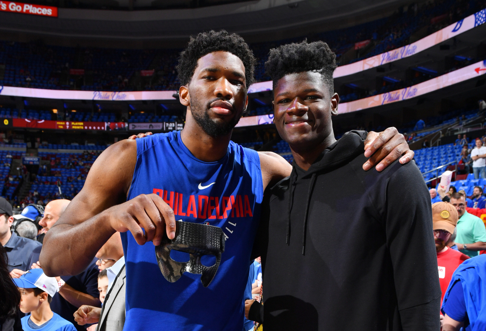 PHILADELPHIA, PA - APRIL 14:  Joel Embiid #21 of the Philadelphia 76ers poses for a photo with Mohamed Bamba prior to game one of round one of the 2018 NBA Playoffs against the Miami Heat on April 14, 2018 at Wells Fargo Center in Philadelphia, Pennsylvania NOTE TO USER: User expressly acknowledges and agrees that, by downloading and/or using this Photograph, user is consenting to the terms and conditions of the Getty Images License Agreement. Mandatory Copyright Notice: Copyright 2018 NBAE (Photo by Jesse D. Garrabrant/NBAE via Getty Images)