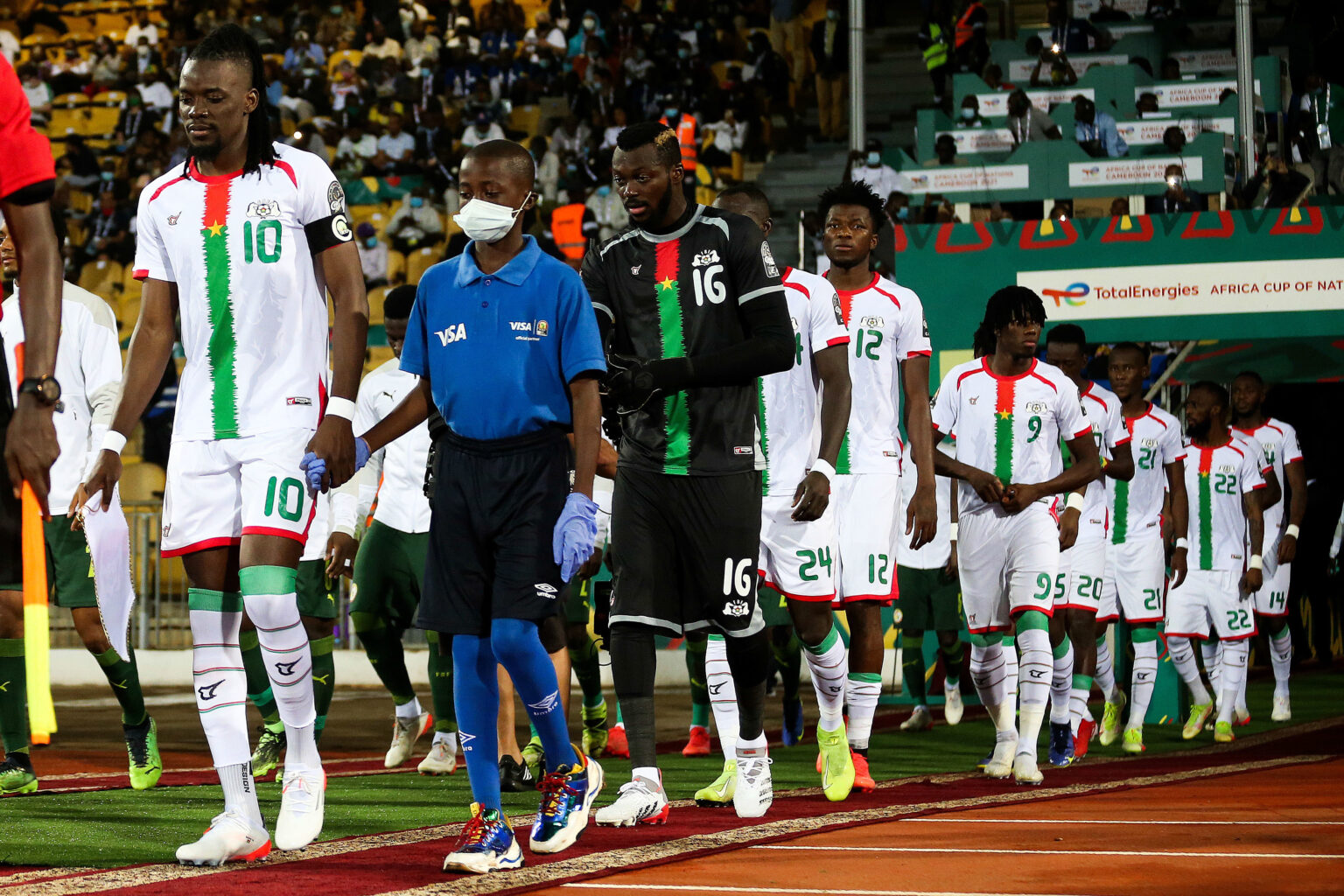 Burkina Faso captain Bertrand Traore leads his players out with the Visa Mascot during the 2021 Africa Cup of Nations Afcon Finals Semifinal match between Burkina Faso and Senegal held at Ahmadou Ahidjo Stadium in Yaounde, Cameroon on 02 February 2022 ©Shaun Roy/Sports Inc - Photo by Icon sport