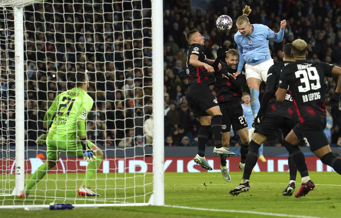 Manchester City's Erling Haaland heads the ball which led to scoring his side's fifth goal of the game during the Champions League round of 16 second leg soccer match between Manchester City and RB Leipzig at the Etihad stadium in Manchester, England, Tuesday, March 14, 2023. (Nick Potts/PA via AP)
