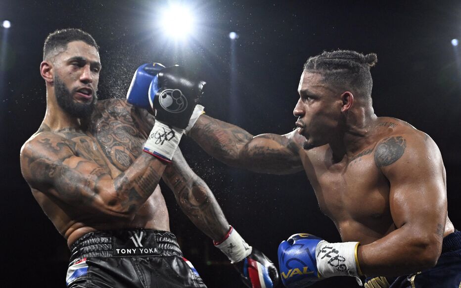 France's Tony Yoka (L) competes against Belgium's Ryad Merhy in their International Heavyweight boxing bout at the Roland Garros complex in western Paris, on December 9, 2023. (Photo by Miguel MEDINA / AFP)