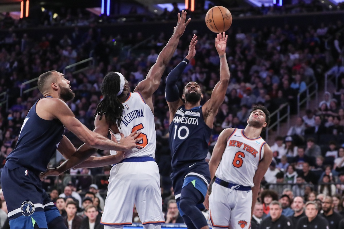 Jan 1, 2024; New York, New York, USA;  Minnesota Timberwolves guard Mike Conley (10) looks to drive past New York Knicks forward Precious Achiuwa (5) in the second quarter at Madison Square Garden. Mandatory Credit: Wendell Cruz-USA TODAY Sports