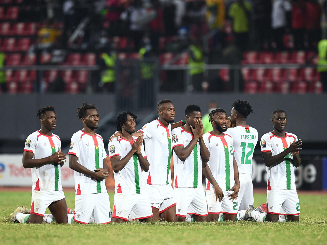 Burkina Faso's players react before their winning shot in a penalty shoot-out  during the Africa Cup of Nations (CAN) 2021 round of 16 football match between Burkina Faso and Gabon at Limbe Omnisport Stadium in Limbe on January 23, 2022. (Photo by CHARLY TRIBALLEAU / AFP)