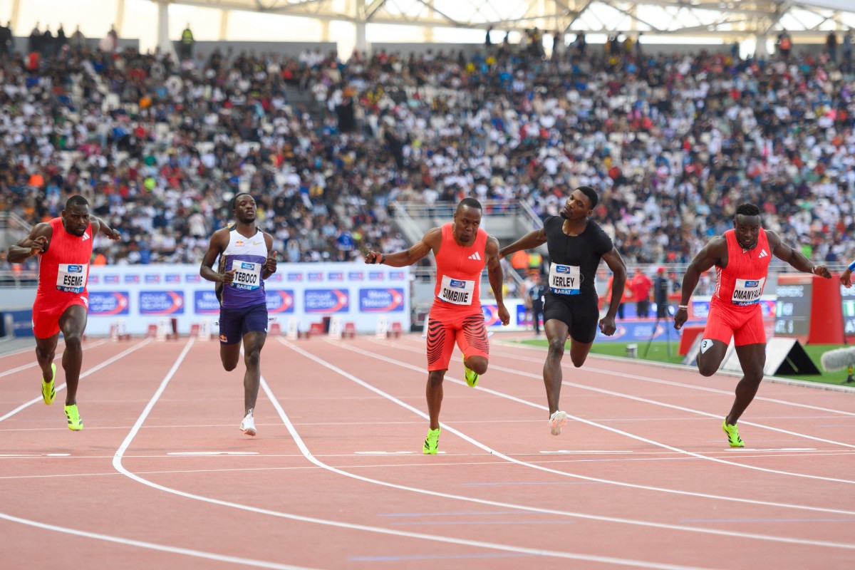 South Africa's Akani Simbine (C) finishes to win the 100m men's during the IAAF Diamond League competition at Prince Moulay Abdellah Stadium in Rabat on May 25, 2025. (Photo by Issam ZERROK / AFP)