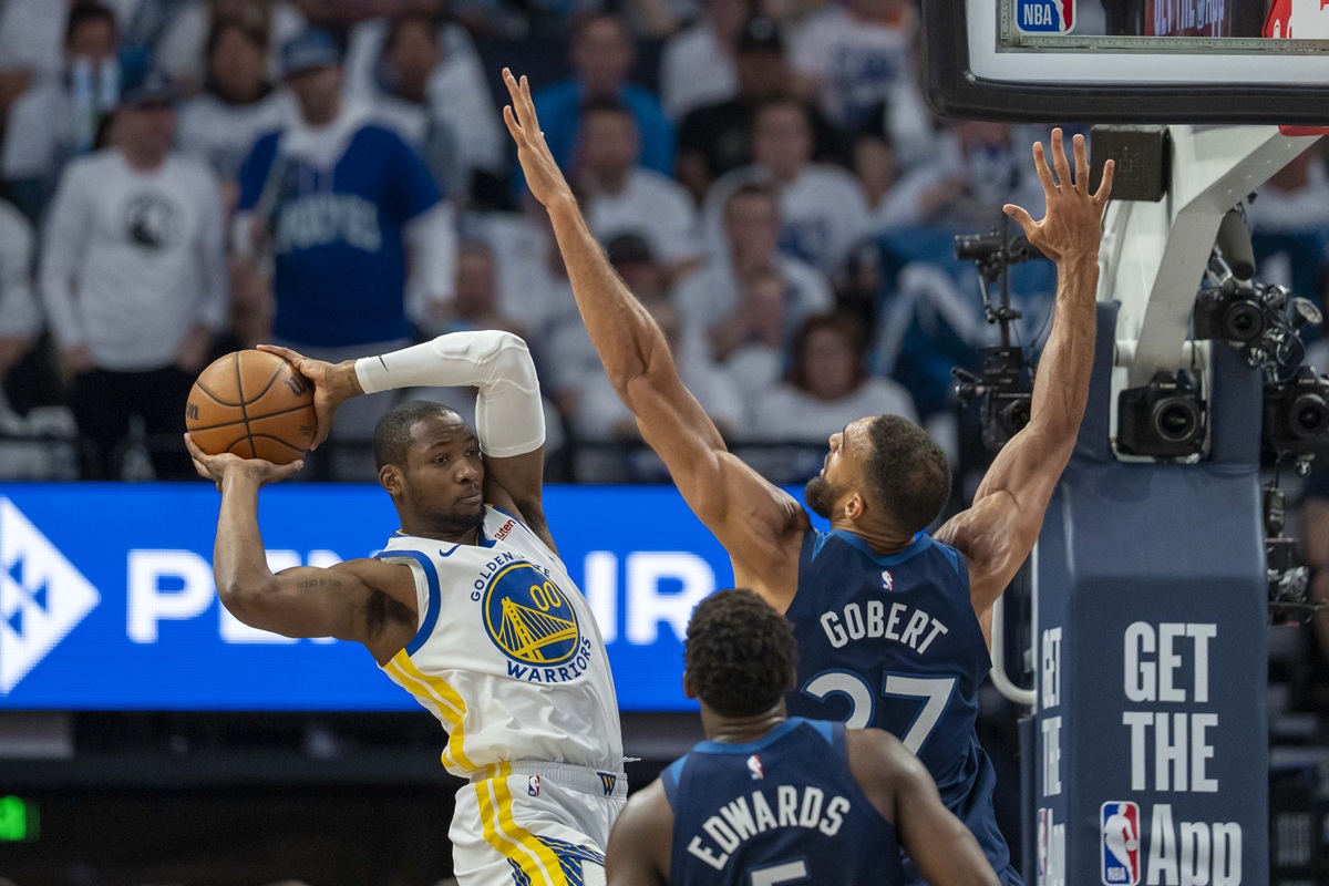 May 8, 2025; Minneapolis, Minnesota, USA; Golden State Warriors forward Jonathan Kuminga (00) looks to pass the ball over Minnesota Timberwolves center Rudy Gobert (27) in the first half during game two of the second round for the 2025 NBA Playoffs at Target Center. Mandatory Credit: Jesse Johnson-Imagn Images